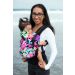 Lady with spectables carries a toddler in a Tula Pixelated Baby Carrier