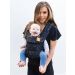 Mom puts baby in front facing position in a Tula Explore Discover Baby Carrier