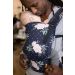 Daddy front carries newborn in a Tula Free-To-Grow baby Carrier Blossom