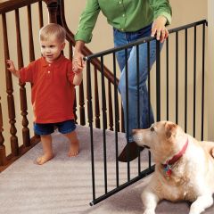 Kidco G2001 Safeway Wall Mounted Safety Gate Black used by mom with baby in arm climbing upstairs at the top of stairs