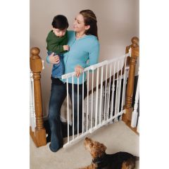 Kidco G2100 Angle Mount Safeway Wall Mounted Safety Gate White used by mom with baby in arm climbing upstairs at the top of stairs