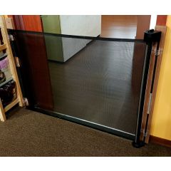 Smart Retract Retract-A-Gate Retractable Baby & Pet Safety Gate in black used at a doorway
