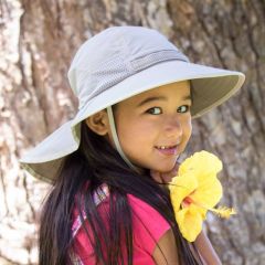 Girl wearing a Sunday Afternoons UPF50+ Kids Play Hat Cream Sun Protection Hat in Cream color