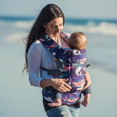 Beco Gemini Starry Seas Baby Carrier used by lady walking with baby at the seaside