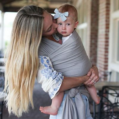  Lady kisses baby in a Boba Wrap Bamboo Light Grey